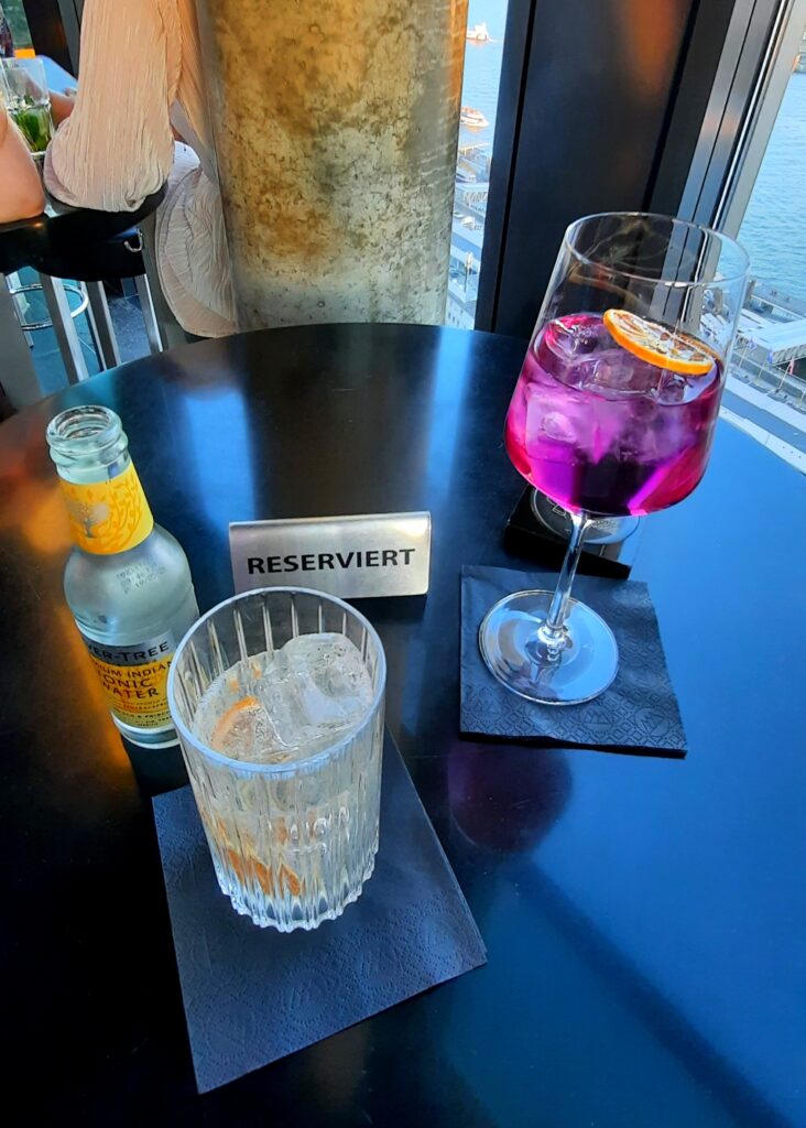 Pink 20up Spritz and gin and tonic on our reserved table at 20up Skyline Bar in Hamburg.