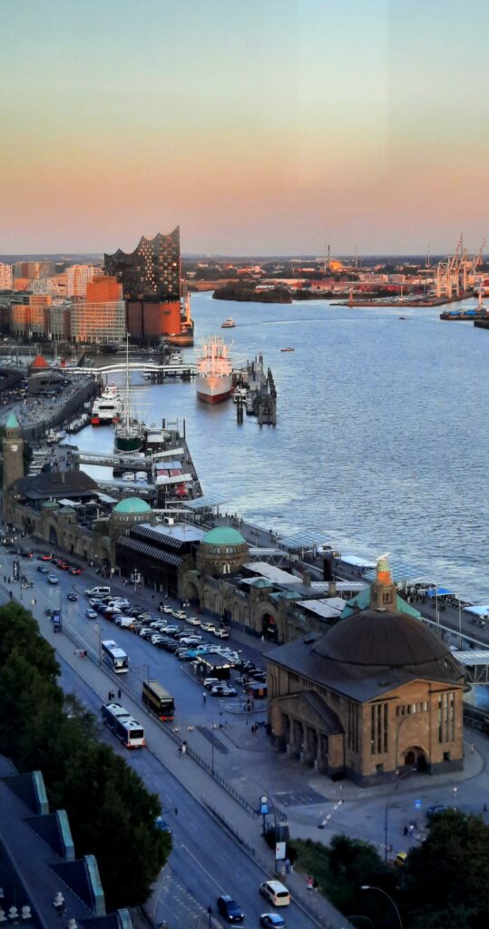 Sunset view over Hamburg harbour and the Elbe from 20up Skyline Bar, with the Elbphilharmonie in the distance.