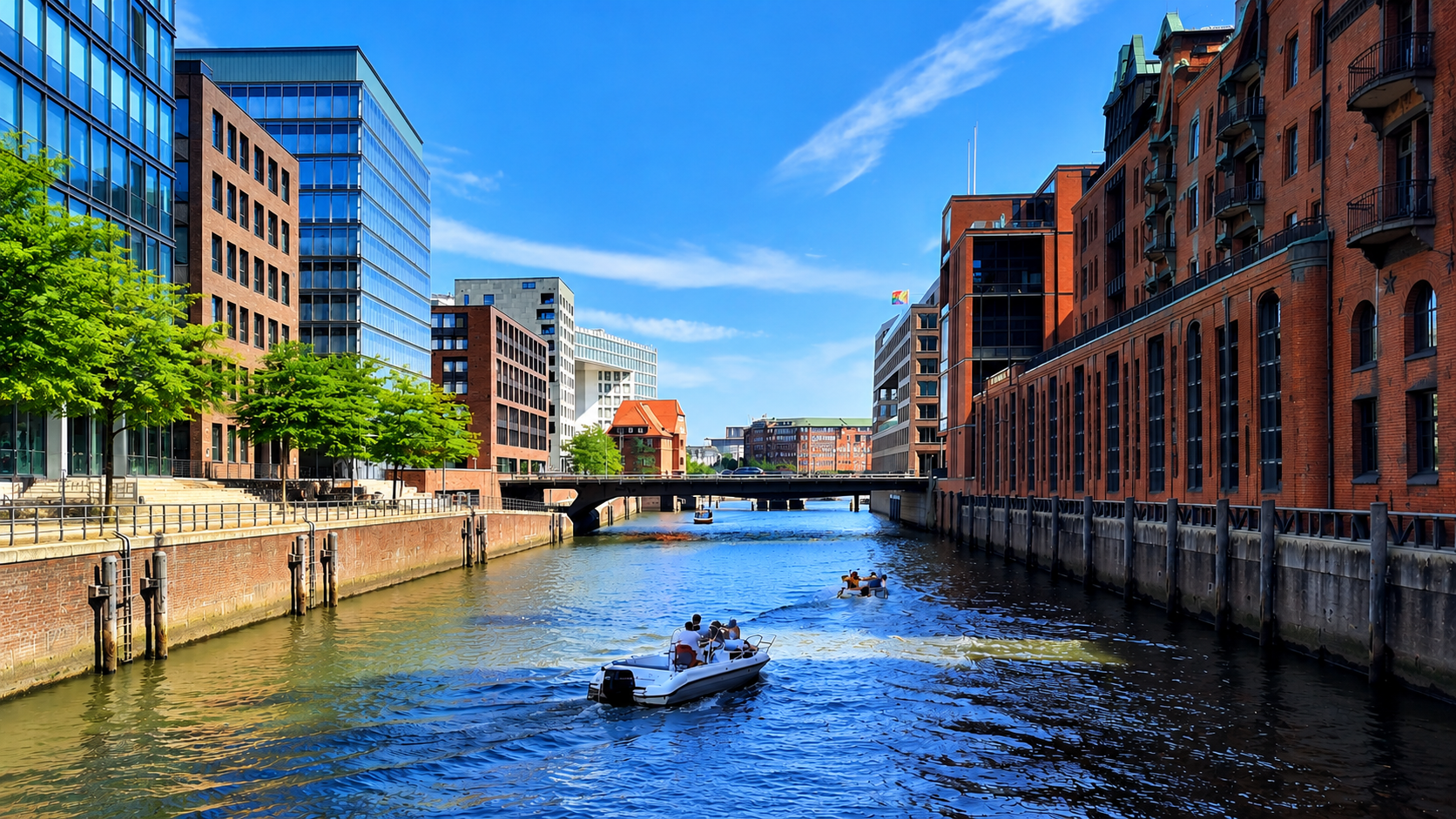 View along a Hamburg canal with red-brick warehouses, modern buildings and boats on the water