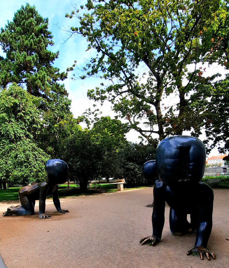 Two large black crawling baby sculptures by David Černý in Kampa Park, Prague.