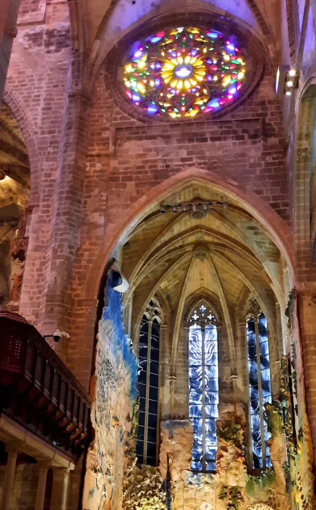 Colourful stained-glass rose window and Gothic architecture inside Palma Cathedral in Mallorca